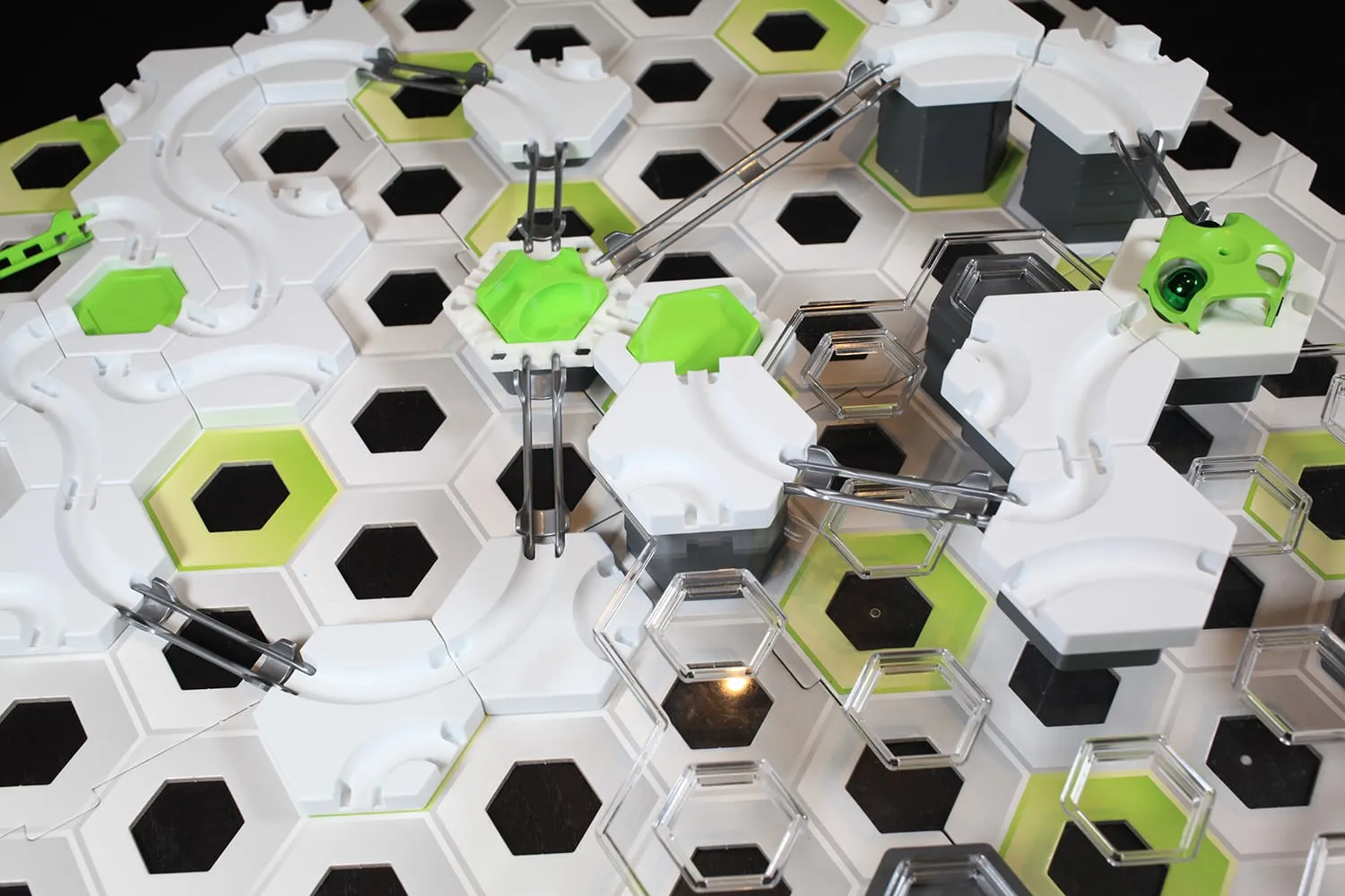 Circuit GraviTrax complexe organisé autour de la plaque à pièce verte, vue en plongée