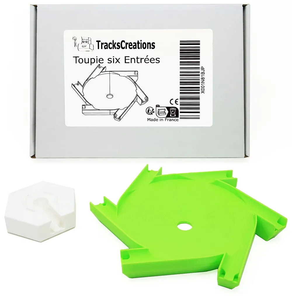 Méga toupie six entrées verte et son support blanc devant la boîte TracksCreations « Toupie six Entrées »