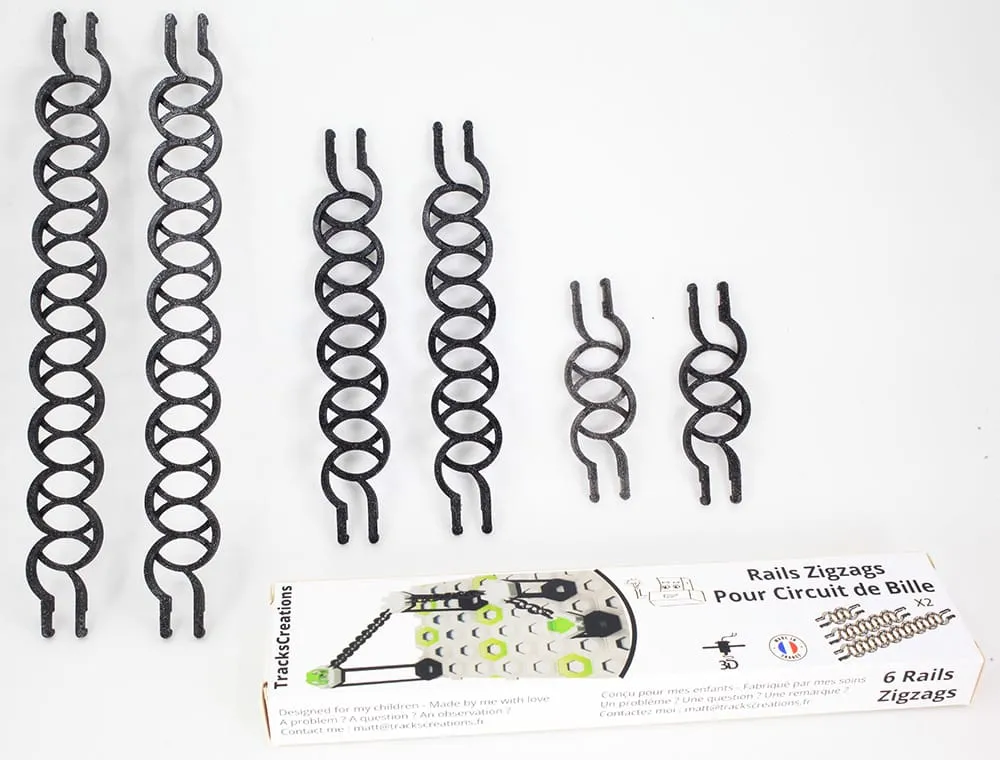 Six rails zigzag noirs de trois tailles devant la boîte « Rails Zigzags »